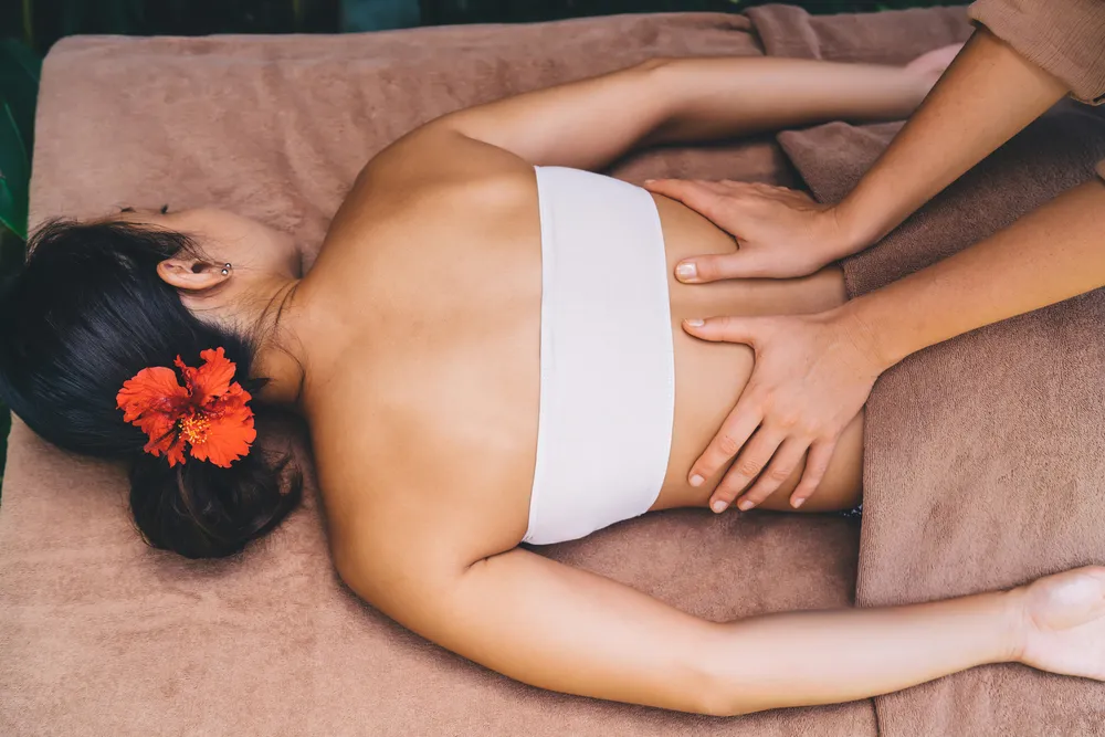 a new mother experiencing tcm postnatal massage at a clinic in Singapore