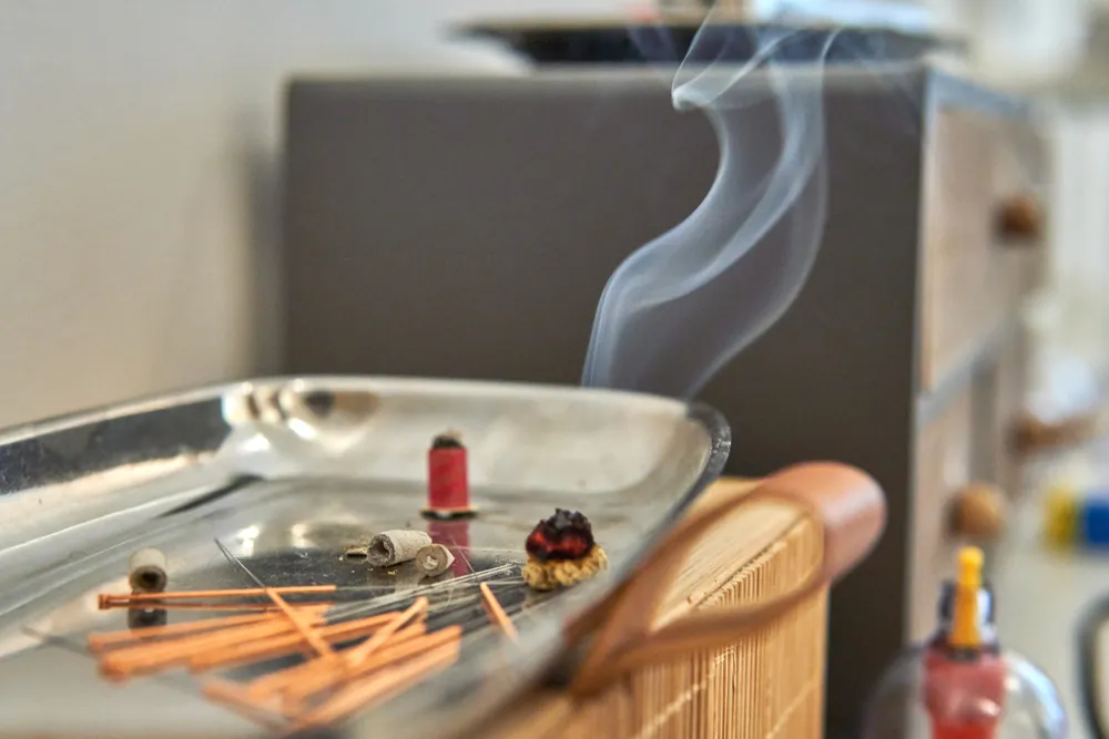 TCM Chinese medicine tools and herbal ingredients arranged on a treatment tray for wellness therapy